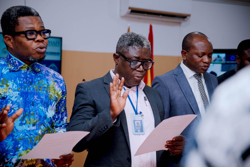 Joint Steering Committee members taking the oath of office with one member raising his right hand.