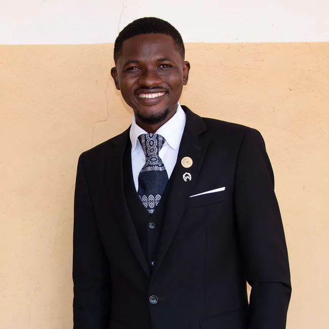 Smiling graduate in a suit - professional studies
