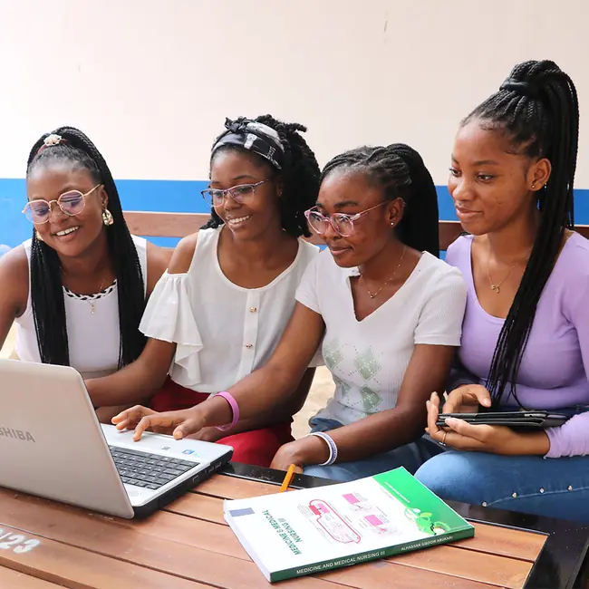 Students working together on a laptop - undergraduate programmes